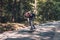 Longboard skating - Skateboarder ride a longboard through the forest