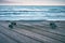 longboard on wooden pier against the background of the sea without people