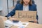 Longhaired man with placard in the office