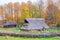 Longhouse at a meadow with a fence in autumn