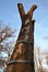 The longitudinally cracked oak tree trunk is repaired by an arborist using a metal hoop bolted around the torso. The tree was stru