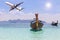 Longtail boats on andaman tropical sea in Thailand with airplane landing