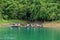 Longtail boats floating on emerald green waters