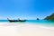 Longtail Boats Moored At Aonang Beach Against Blue Sky