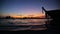 Longtail boats on seashore at sunset