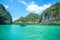 Longtail boats and speed boats in the sea near Hong island in Krabi Province Thailand