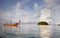 Longtail wooden boat in the calm sea with beautifull cloudy sky