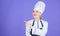 Look at this. Adorable chef or professional cook. Master chef smiling and gesturing in cook uniform. Sensual woman in