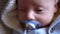 look of baby in camera close up shot. infant, childhood, parental love, emotion concept - cute smiling face of brown