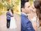 Look from behind at gorgeous wedding couple kissing
