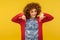 Look below, nice advertise here! Portrait of happy pretty curly-haired woman pointing down and smiling charming