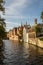 Look from a bridge to old buildings at brugge canal