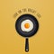 Look on the bright side - background with quote and fried egg illustration on a black pan.