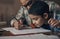Look closer and youll understand so much more. an adorable little boy completing a school assignment with his father at