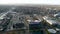 Look down on a college football arena and pan to view of local town