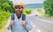 Look for fellow travelers. Tips of experienced tourist. Man bearded hipster tourist at edge of highway. Looking for