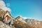 Look forward to the thrill of getting to the top. a young woman taking a break while out on a hike through the mountains