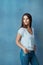 Look how far youve come. Studio shot of an attractive young woman looking thoughtful against a blue background.