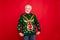 Look I got wonderful present. Portrait of positive cheerful funky old man show his theme christmas party sweater deer