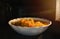 Look inside the microwave food white bowl, In a warm atmosphere and empty top space for text. Spicy food.