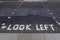 Look left written on the pavement at the pedestrian or puffin crossing in central London, England