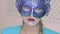 Look of the mysterious girl in venetian mask with winter art makeup