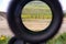 A look through an optical sight aimed at a group of potential targets at the range