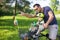 Look over there. Active family day in nature. Father and son ride bike through city park on sunny summer day. A cute boy