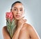 Look to nature, she knows all about natural beauty. Studio shot of an attractive young woman holding a protea flower and