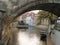 Look under the arches of the Gothic Charles Bridge on the water with boat