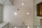 Look up on suspended ceiling with halogen spots lamps and drywall construction with fire alarm sensor in empty room in apartment