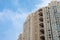 A look up to a newly constructed Chinese apartment with a nice blue sky.