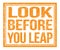 LOOK BEFORE YOU LEAP, text on orange grungy stamp sign