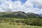 Looking across fields to Buckbarrow and Middle Fell, Lake District