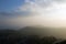 Looking across the ridge and woodlands of the Malvern Hills on a cold, frosty, misty afternoon. Worcestershire, UK.