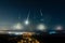 Looking across a town and countryside at night as asteroids impact the earth