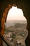 Looking through the arches of Mehrangarh Fort overlooking Jodhpur at sunset