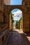 Looking through an archway in a side street out towards the beautiful and stunning Tuscan countryside from the town of Pienza,