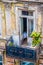 Looking down on a balcony in a grungy deteriorated but beautiful and ornate balcony in Eastern Europe with bed visiable through