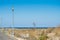 Looking down the boardwalk with diminishing perspective and blue ocean and deep blue sky