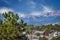 Looking down at a church and other buildings and a parking lot full of cars with the Rocky Mountains in the background in Colorado