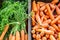 Looking down on a display of carrots on a market stall