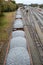 Looking down on a line of loaded rail cars loaded with gravel.