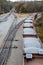 Looking down on a line of loaded rail cars loaded with gravel.