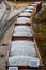 Looking down on a line of loaded rail cars loaded with gravel.