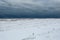 Looking down a massive buildup of snow, sand and ice on Lake Michigan on gloomy overcast day