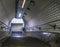 Looking down metal stairs with curved tile tunnel ceiling in London Metro