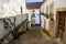 Looking down a narrow cobblestone alley at brightly colored homes in Obidos Portugal