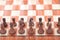 Looking down on the neatly arranged chess pieces on the chessboard