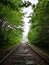 Looking down old railroad tracks in summer on a rainy day